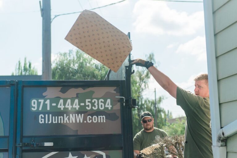 Close-up of a camouflage truck door with an American flag decal and 'Veteran Owned and Operated' lettering